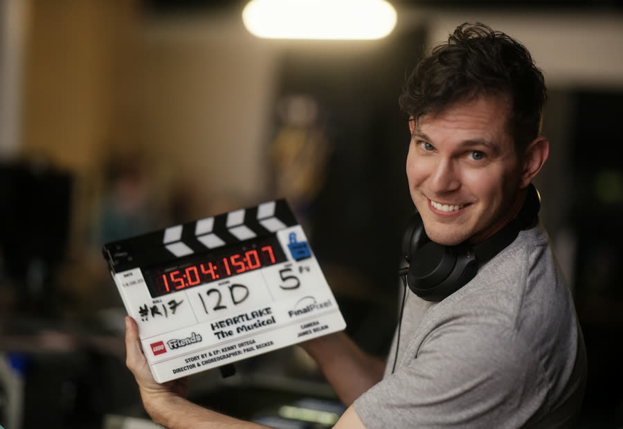 Paul Becker on set with Heartlake clapperboard